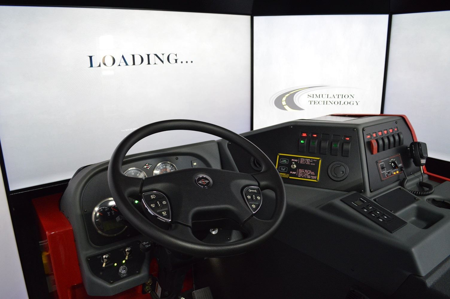 The driver's seat of the regional driving simulator is surrounded by screens used to project roadway scenarios.